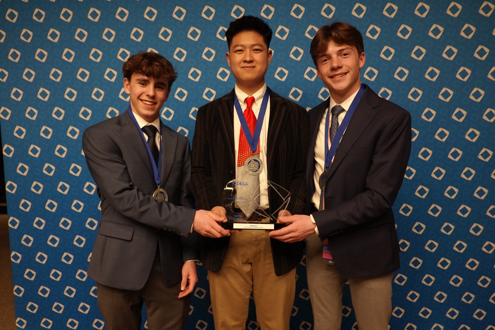 Petfoodz founders holding their trophy at the Wisconsin DECA state competition